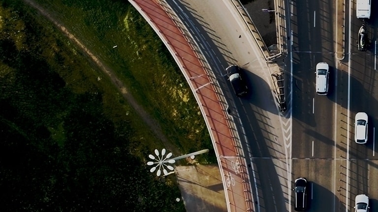 Overhead shot of cars driving on a highway.