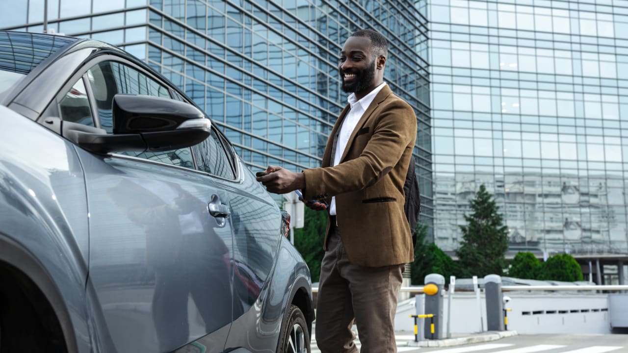 Man getting into his car after a day of work.
