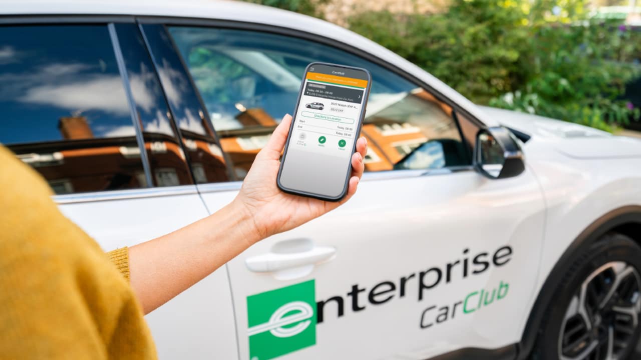 Phone with the "Enterprise Car Club" app open.