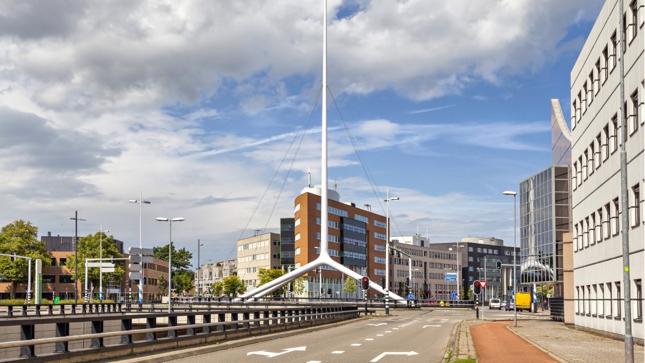 Thin white steeple on one of the crossroads of Eindhoven, Netherlands