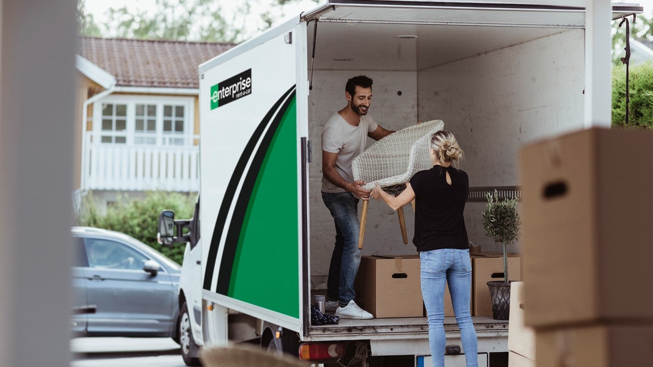 Couple unpacking a moving van